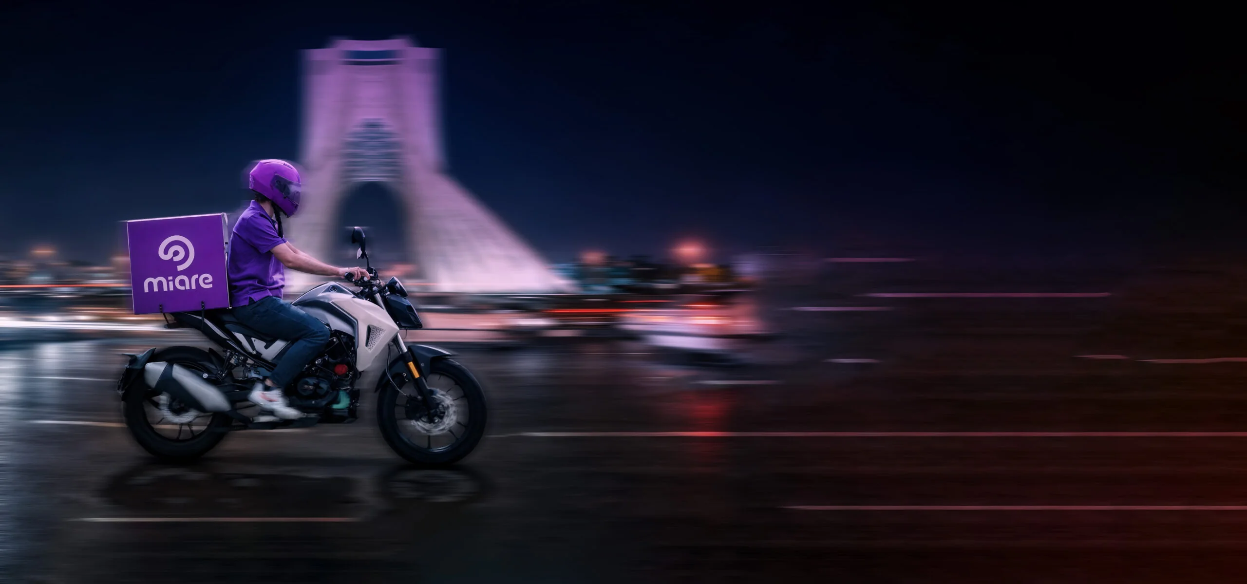 Miare motorbike courier riding through Tehran at night
